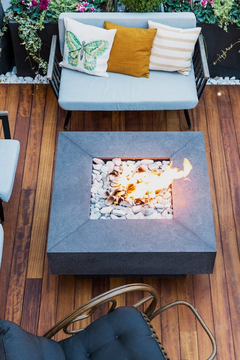 A top-down view of a modern patio featuring stylish furniture and a central firepit.